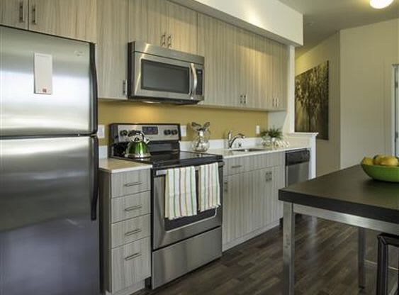 a kitchen with stainless steel appliances and a microwave