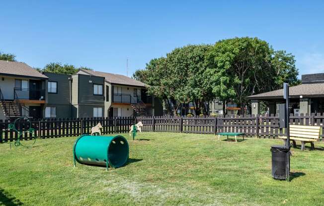 Large dog park at Fusion Fort Worth apartment complex in Haltom City, TX with grey picket fence and green lawn