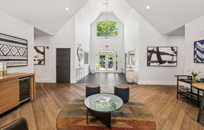 A living room with a rug and a coffee table.