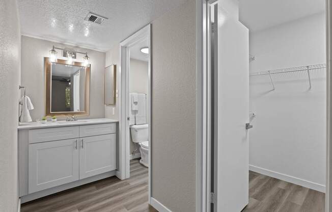 A bathroom with a white cabinet and a white toilet.