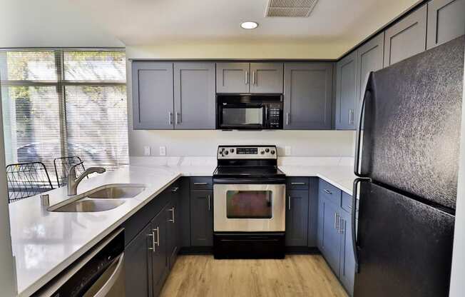 a kitchen with black appliances and white counter tops