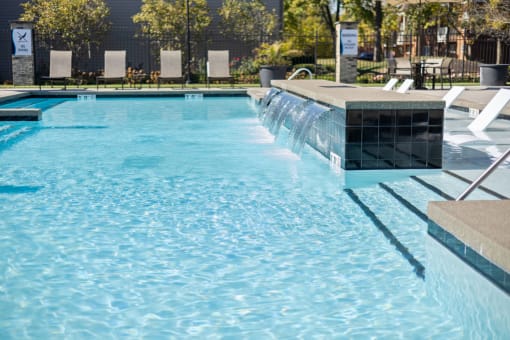 a large pool with a waterfall in the middle