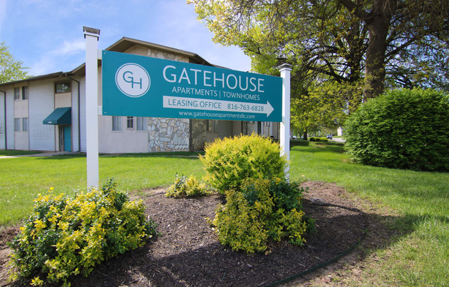 the gatehouse apartments sign in front of a building