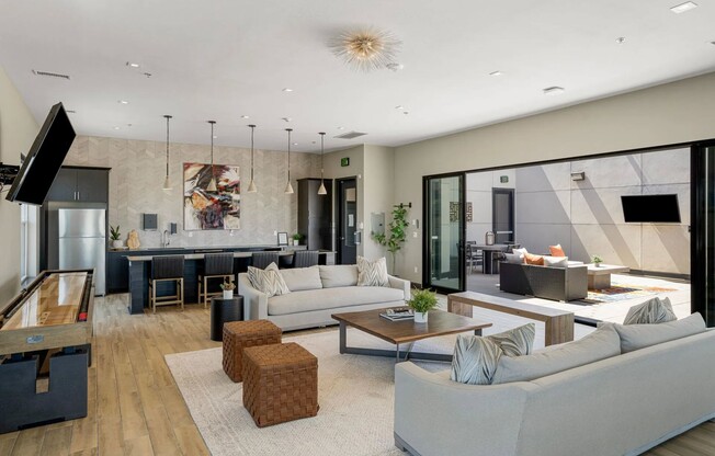 Step into the inviting lounge area at Flats on Archer, where modern design meets comfort. Natural light floods the space, creating a warm atmosphere perfect for socializing or relaxation. Explore your new lifestyle today!