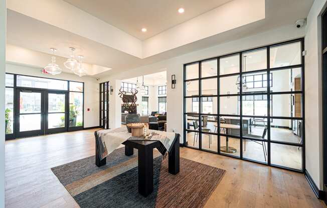 a large living room with glass doors and a table