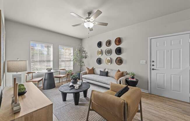 a living room with a ceiling fan and a couch