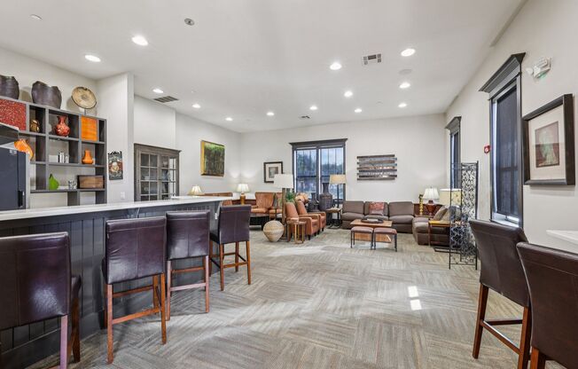 A living room with brown leather chairs and a grey carpet.