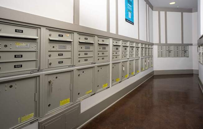 A long row of metal filing cabinets with yellow labels on them.