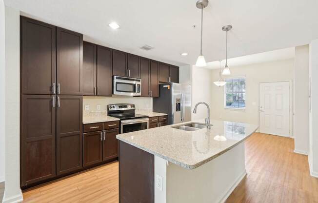 A kitchen with brown cabinets and a white island.
