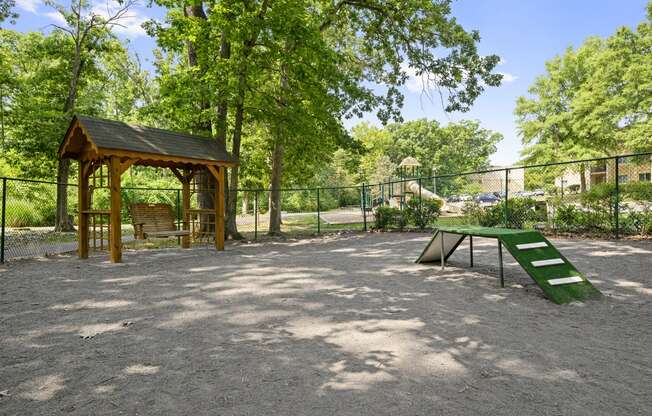 a picnic area with a picnic table and a bench in a park