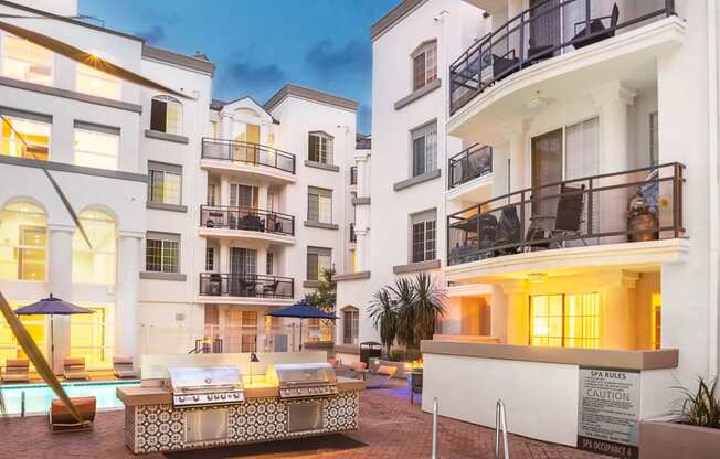 Dog-Friendly Apartments in Los Angeles, CA - The Preston - BBQ Grill Beside Pool with Jacuzzi and View of Apartment Buildings