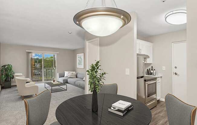 Model dining area with a table and chairs at Stone Ends apartments in Stoughton, MA
