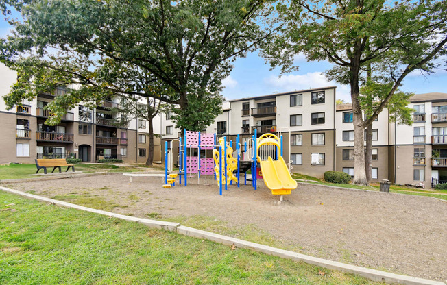 A playground with a yellow slide and a yellow slide in the middle of the playground.