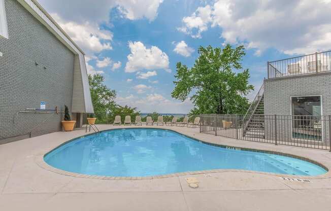 the pool and sundeck with loungers at Mountainside Apartments in Birmingham, AL