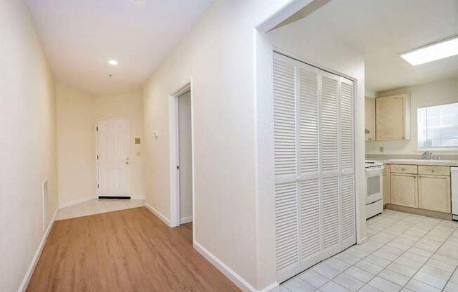 A kitchen with white cabinets and a white door.