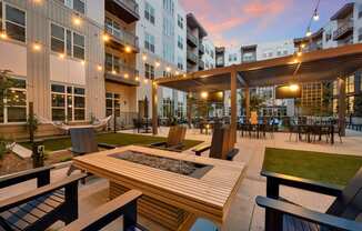 an outdoor patio with tables and chairs at an apartment complex