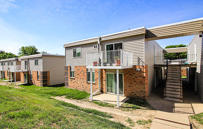 a row of houses with a stairway leading up to a balcony
