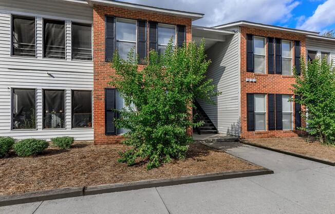 a garden in front of a brick building