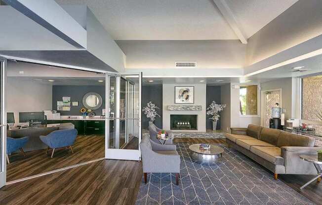 A modern living room with a fireplace and a dining area.