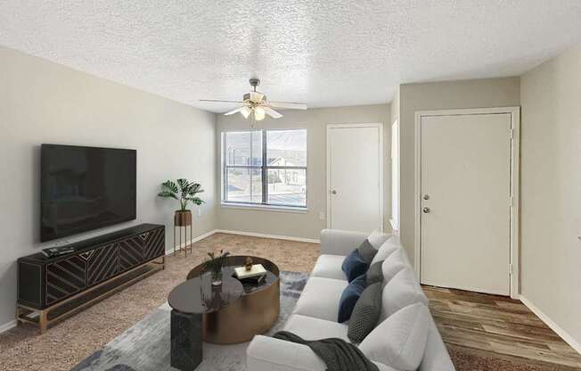 A living room with a television, a coffee table, and a couch.