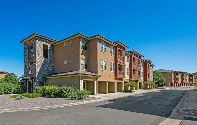 A row of modern apartment buildings with a clear blue sky above.