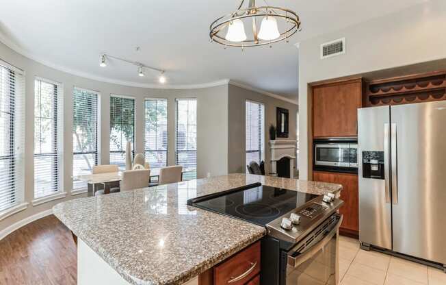 a kitchen with granite counter tops and stainless steel appliances