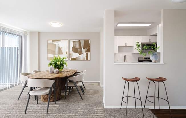 a dining room with a table and chairs and a kitchen