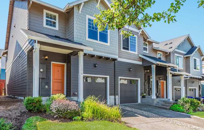 Townhomes with a grey exterior and a brown door at The Landing Apartments and Townhomes, Oregon, 97045