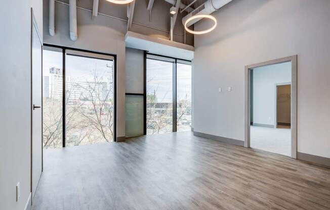 A room with a view of the city through large windows.