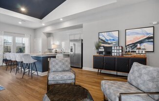 a living room with a kitchen and a table and chairs