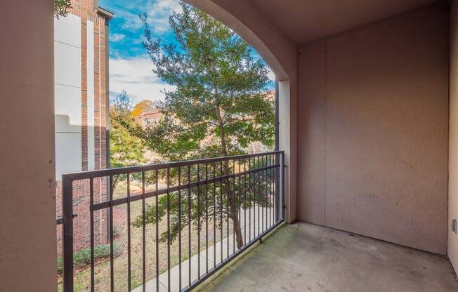 a balcony with a view of a tree and a balcony fence at Crogman School Lofts, Atlanta