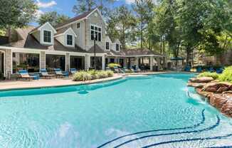 A large house with a pool in front.