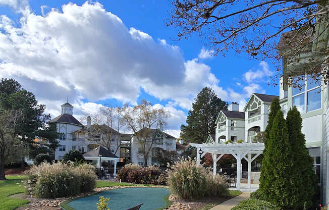 A bench is on a wooden deck next to a pool.