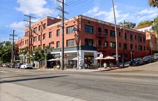 a large brick building on a city street at Del Mor Apartments, Los Angeles, California