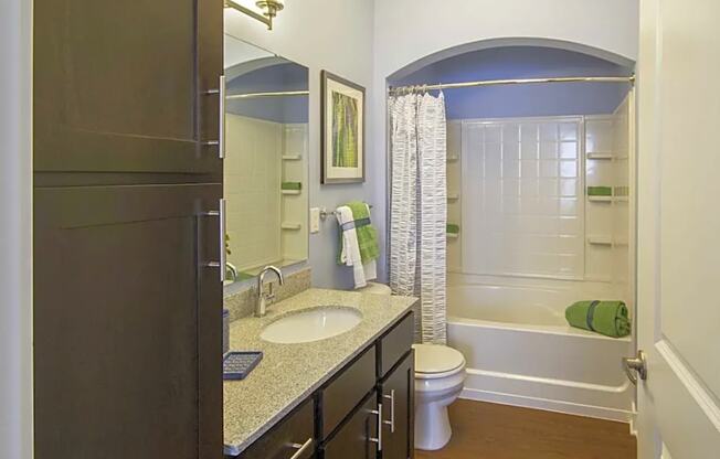 A bathroom with a sink, toilet, and bathtub.