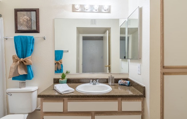 Cantera bathrooms with vanity sinks and shower tub combo