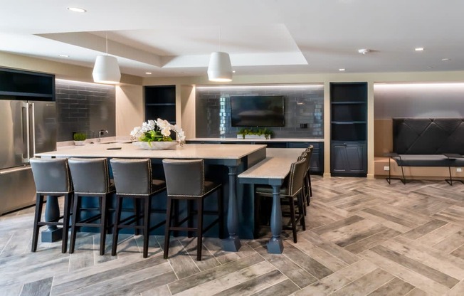 a large kitchen with a large island and chairs