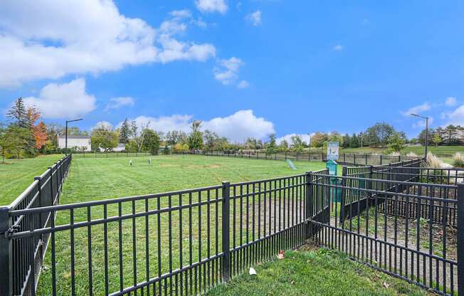 a view of a field behind a fence