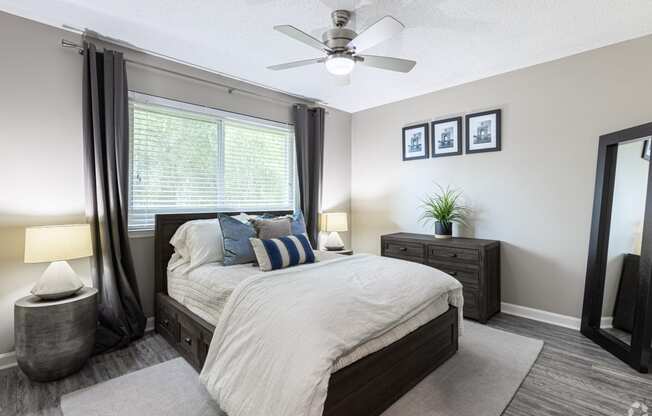 a bedroom with a bed and a ceiling fan