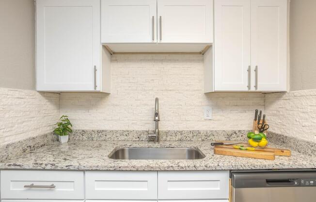 a kitchen with a stove a sink and a microwave