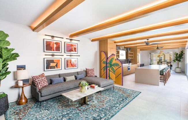 Expansive rooftop clubroom with demonstration kitchen and gathering spaces opening to the rooftop deck.