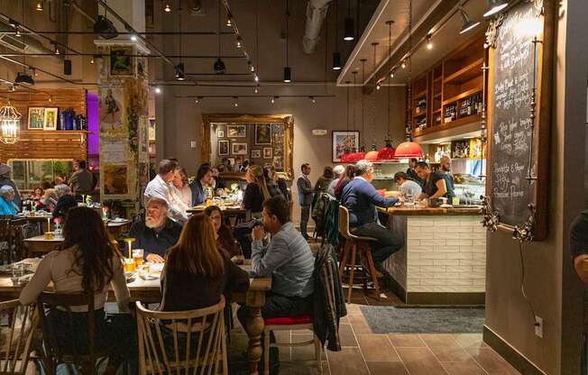 A group of people are sitting at tables in a restaurant.