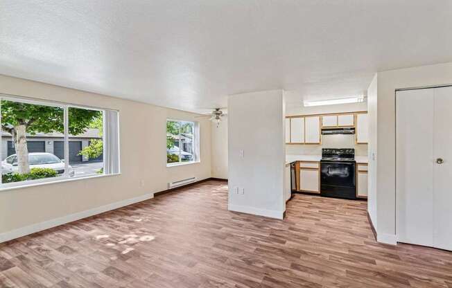 A room with a wood floor and a wall-mounted TV.