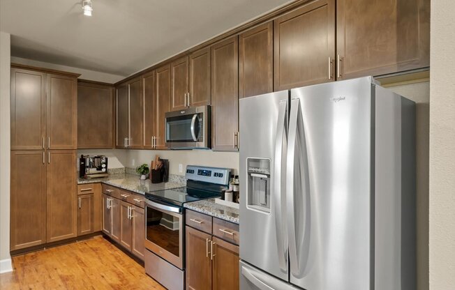 A kitchen with wooden cabinets and stainless steel appliances.
