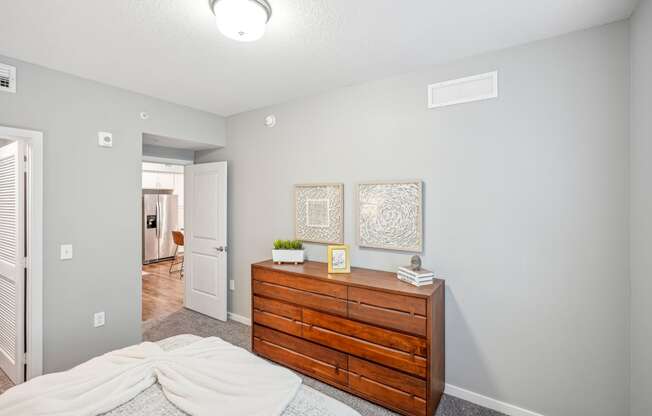 a bedroom with a dresser and a bed