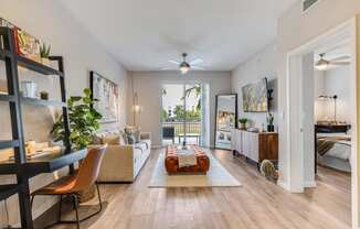 a living room with a couch and a ceiling fan