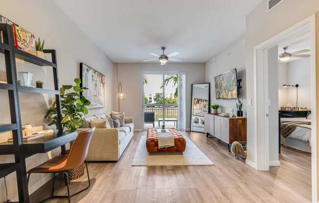 a living room with a couch and a ceiling fan