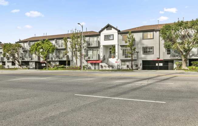 an empty street in front of an apartment building