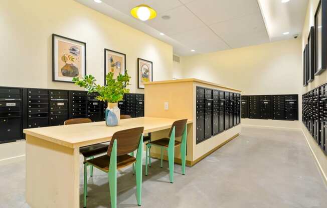 a room with a table and chairs in front of a row of lockers