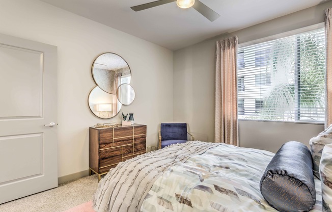 bedroom with ceiling fan bed and night stands at arte apartments